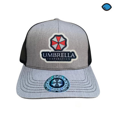 Gorra Resident Evil Umbrella Corporation Gris/Negra Tipo Trucker Premium
